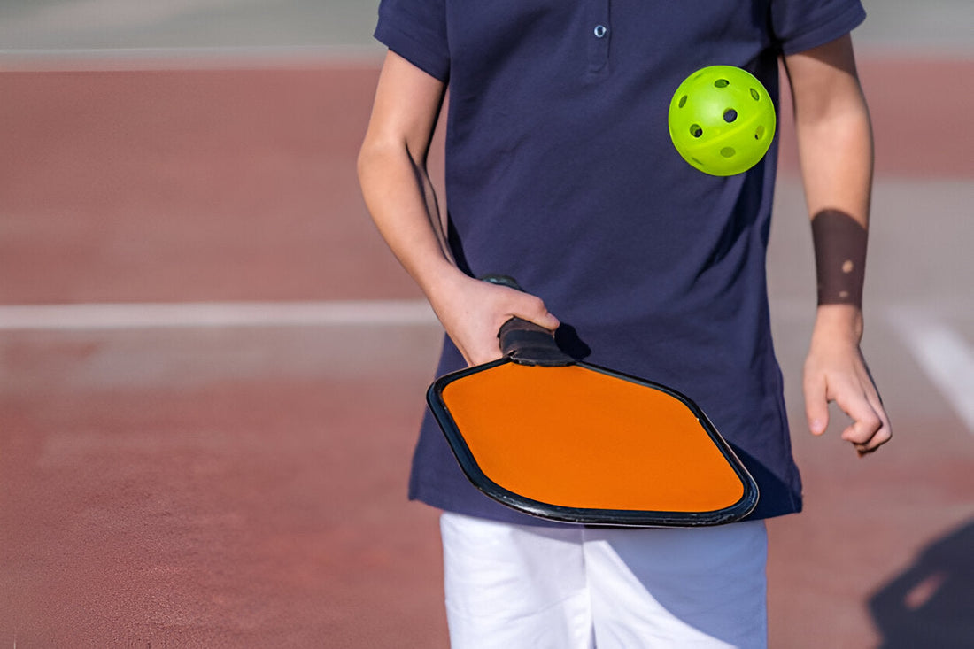 holding a heavy pickleball paddle