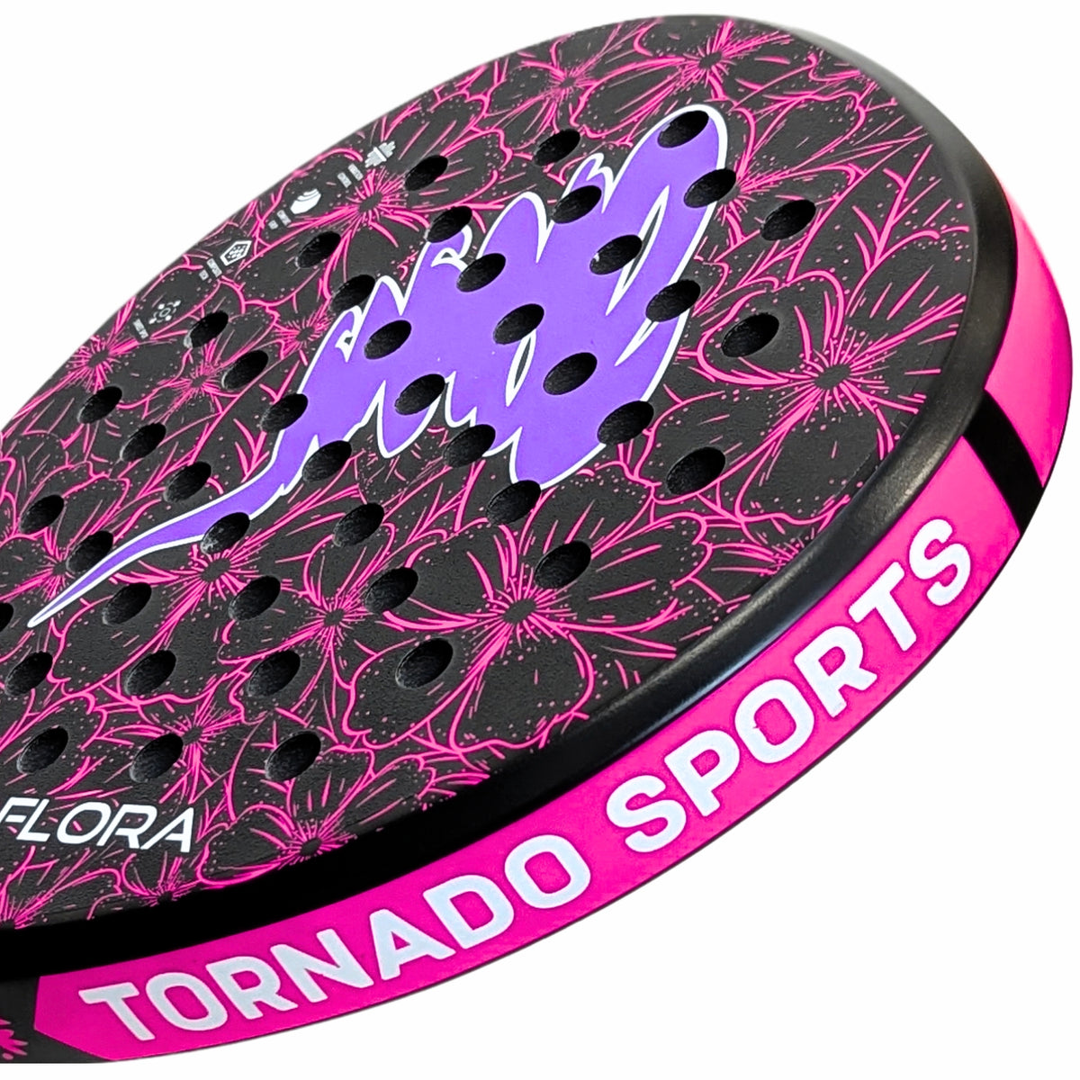 Close-up of a round paddle racket with a black perforated face featuring a purple and pink floral pattern, a purple logo, and a bright pink side edge with the text 'TORNADO SPORTS' and 'FLORA'.