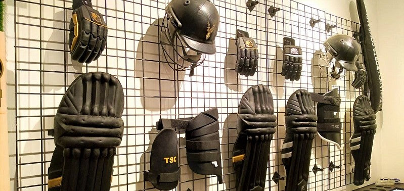 Black cricket gears placed in a cricket store in pakistan and dubai