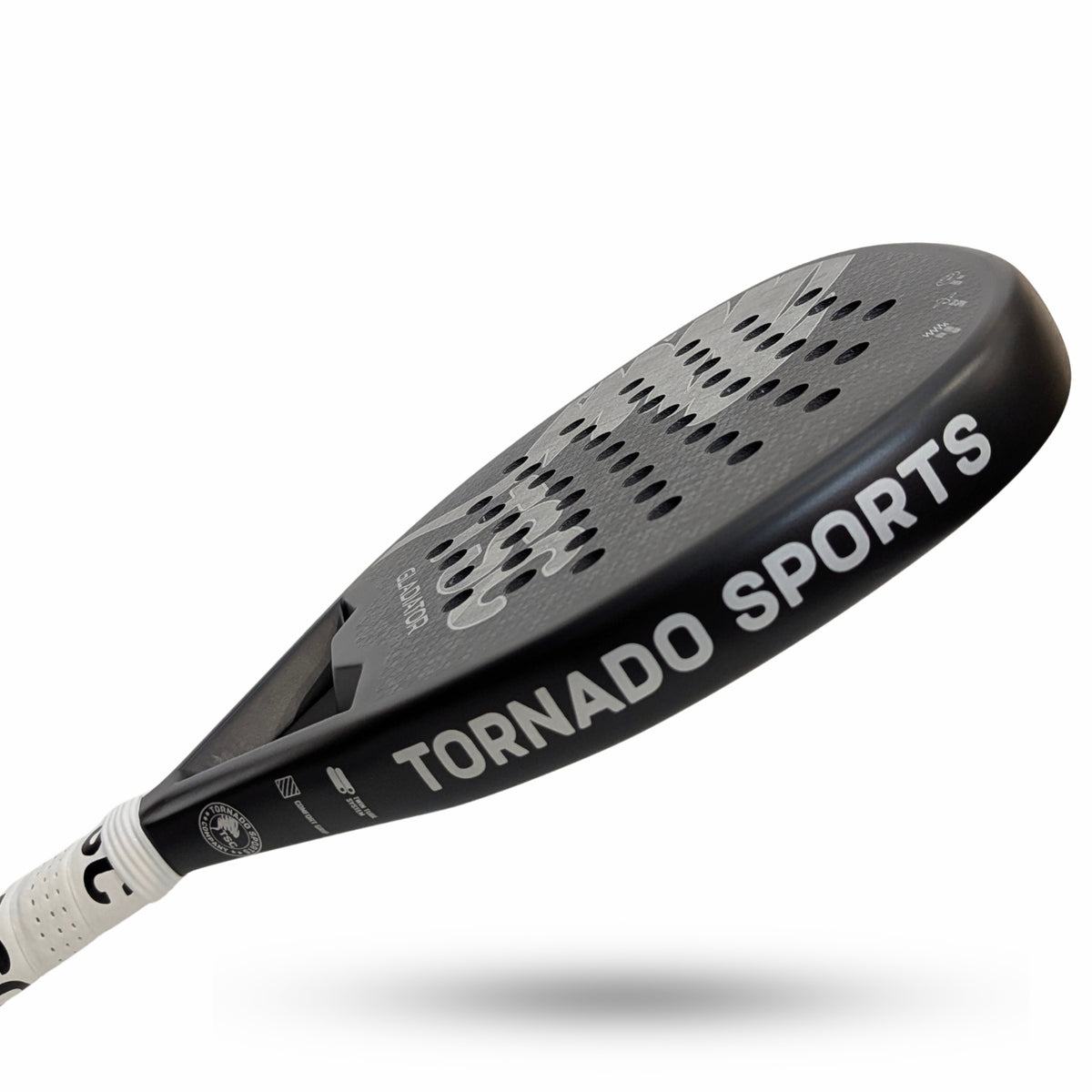 A close-up studio shot of a paddle racquet  and part of the handle on a white background. The paddle racket face is black with a textured pattern of circular cutouts, featuring the brand name 'TORNADO SPORTS' in white.