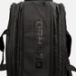 A black Tornado padel tennis bag with a large, tonal black logo printed vertically on the front panel, shown against a light gray background with 2 racket space 