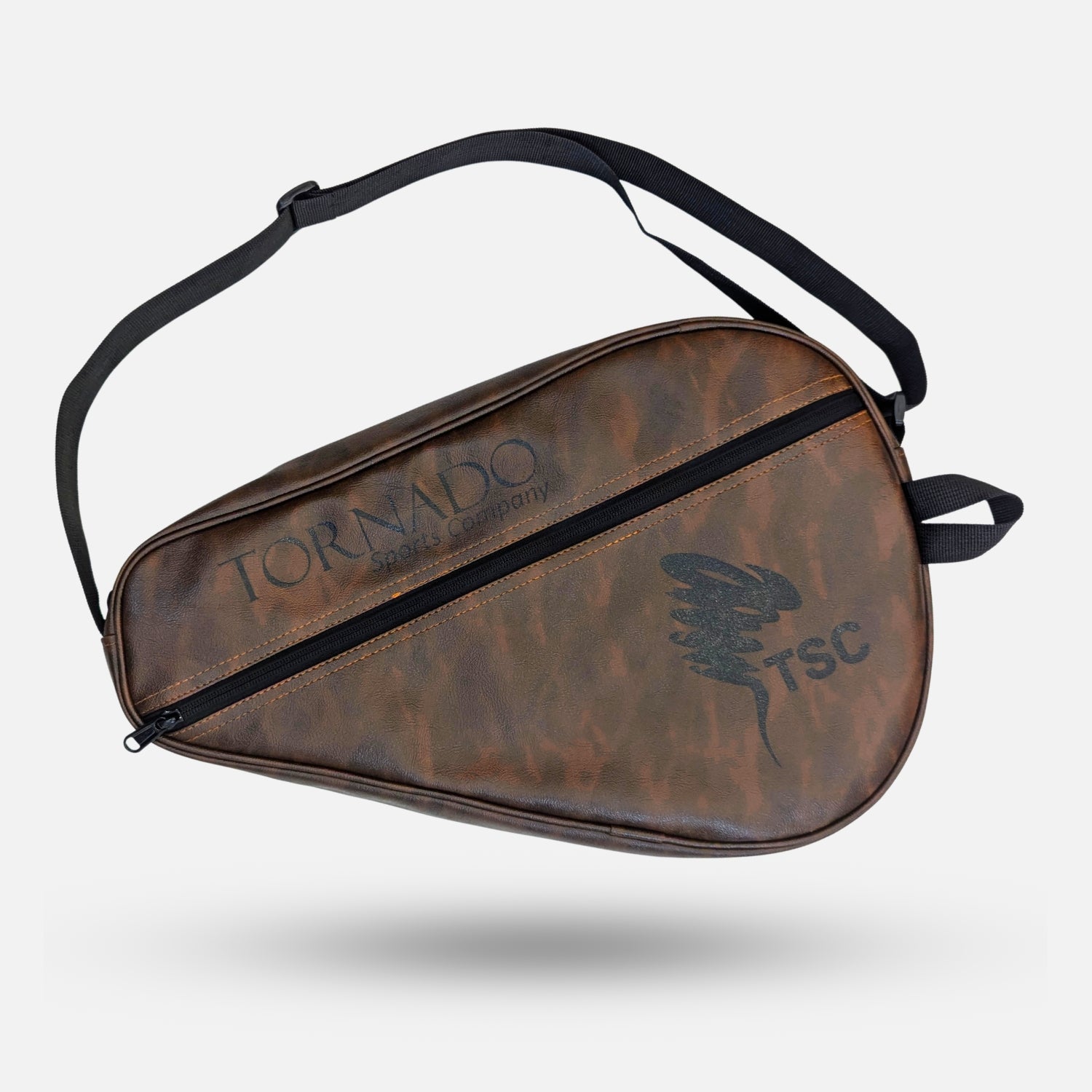 A brown distressed leather Tornado TSC motorcycle shoe bag with a black adjustable shoulder strap, shown floating against a light gray background. padel tennis racket cover