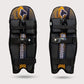 Pair of black and yellow shin guards with 'Tornado' branding on a light gray background cricket molded pads