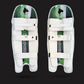 Pair of white cricket leg guards with green and black patterns on a black background