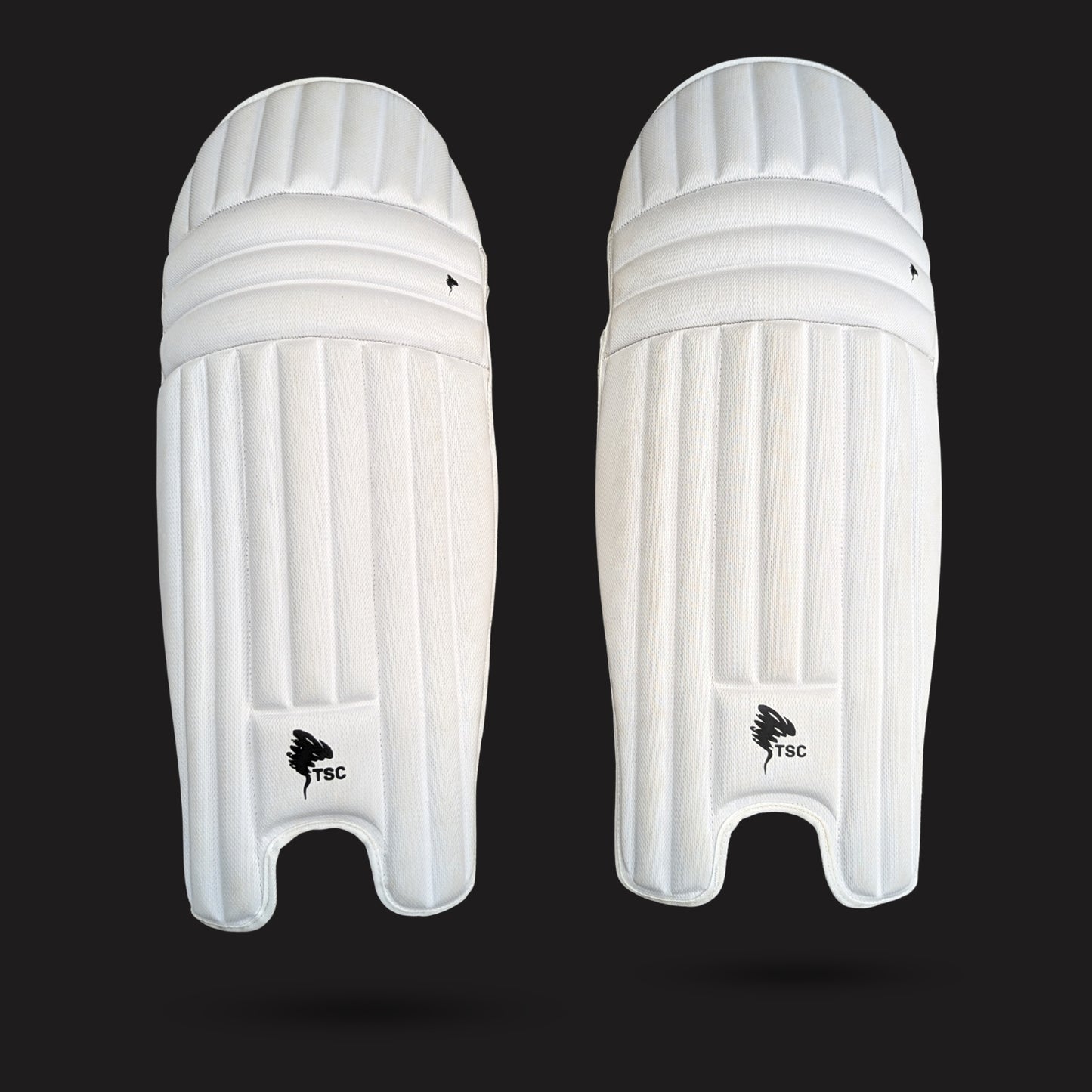 Pair of white cricket leg guards on a black background molded cricket pads front side for men