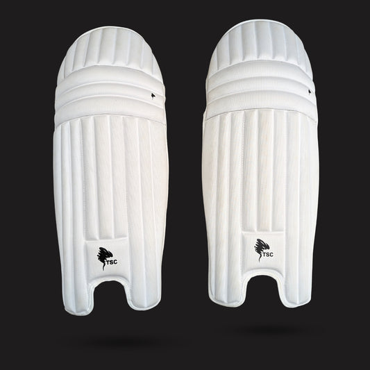 Pair of white cricket leg guards on a black background molded cricket pads front side for men