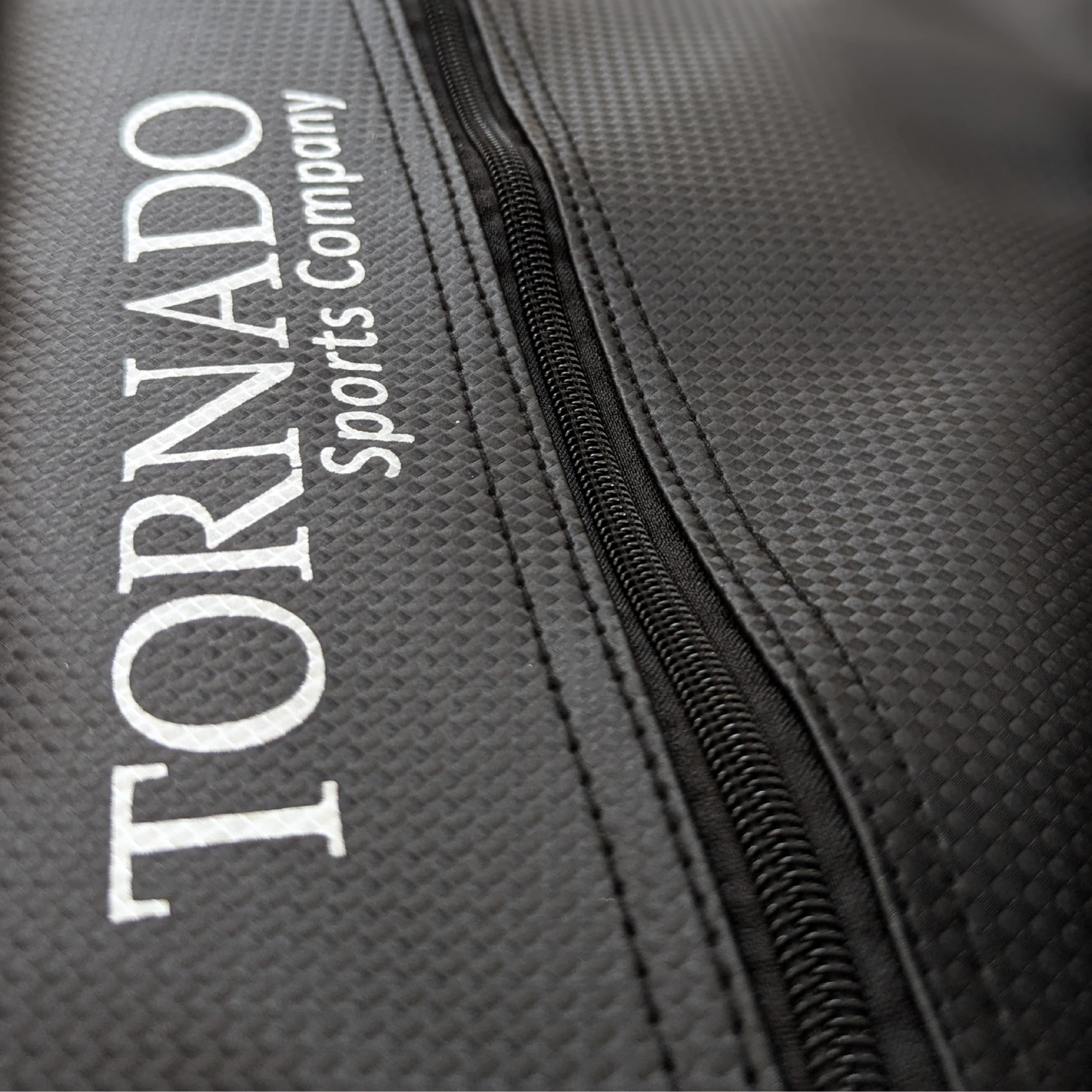 Close-up of a black padel tennis racket cover with 'Tornado Sports Company' branding.
